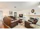 Inviting living room with traditional furnishings, a stone fireplace, and warm, neutral tones at 1104 Pinto Rock Ln # 101, Las Vegas, NV 89128