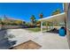 Spacious backyard with a covered patio, mature trees, and ample room for outdoor entertaining at 1316 Borderwood Ln, North Las Vegas, NV 89031