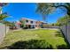 Large backyard featuring lush lawn, covered patio, and block fencing for privacy at 1316 Borderwood Ln, North Las Vegas, NV 89031