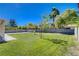 Expansive backyard featuring lush green grass, mature trees, and ample space for outdoor activities at 1316 Borderwood Ln, North Las Vegas, NV 89031
