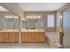 Bright bathroom featuring double sinks, a large mirror, soaking tub, and separate glass shower at 1316 Borderwood Ln, North Las Vegas, NV 89031