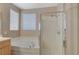 Bright bathroom featuring a large soaking tub and separate glass shower at 1316 Borderwood Ln, North Las Vegas, NV 89031