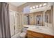 Bathroom showcasing a shower-tub combo, single sink vanity, and ample lighting at 1316 Borderwood Ln, North Las Vegas, NV 89031