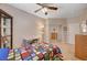 Cozy bedroom featuring ceiling fan, closet with mirrored doors, and desk area at 1316 Borderwood Ln, North Las Vegas, NV 89031