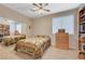 Cozy bedroom with mirrored closet doors, built-in bookshelves, and a comfortable bedspread at 1316 Borderwood Ln, North Las Vegas, NV 89031