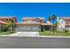 Charming two-story home with a well-manicured lawn and a three car garage at 1316 Borderwood Ln, North Las Vegas, NV 89031