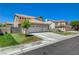 View of the home and a large driveway with well-manicured lawn at 1316 Borderwood Ln, North Las Vegas, NV 89031