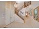 Bright foyer featuring a crystal chandelier, staircase, and a double door entry at 1316 Borderwood Ln, North Las Vegas, NV 89031