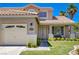 Close up of the front of the house with a manicured lawn and a bench on the porch at 1316 Borderwood Ln, North Las Vegas, NV 89031