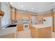 Well-lit kitchen features wooden cabinets, modern appliances, and ample counter space at 1316 Borderwood Ln, North Las Vegas, NV 89031