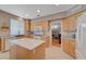 Modern kitchen with island, double sink, stainless steel appliances, and light wood cabinets at 1316 Borderwood Ln, North Las Vegas, NV 89031