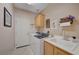 Functional laundry room with washer, dryer, sink, and storage space at 1316 Borderwood Ln, North Las Vegas, NV 89031