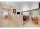 Open-concept living room features a dining area, wall-mounted TV, and plush leather furniture at 1316 Borderwood Ln, North Las Vegas, NV 89031