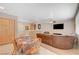 Bright living and dining area featuring tile floors and comfortable brown leather seating at 1316 Borderwood Ln, North Las Vegas, NV 89031