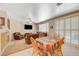 Open-concept living room has tile floors, fireplace, with easy access to dining area at 1316 Borderwood Ln, North Las Vegas, NV 89031