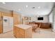 Open-concept kitchen seamlessly connects to a living space with dining table and comfortable seating at 1316 Borderwood Ln, North Las Vegas, NV 89031