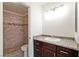 Bathroom features granite counters, wood cabinets and tiled shower at 1663 Cloister Ave, Henderson, NV 89014