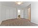 Carpeted bedroom with an adjacent staircase and bathroom at 1663 Cloister Ave, Henderson, NV 89014