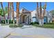 Welcoming entrance to community with palm trees and manicured landscaping and archway at 1663 Cloister Ave, Henderson, NV 89014