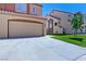 A well-maintained two-story house with a terracotta roof and a spacious driveway leading to the two-car garage at 1663 Cloister Ave, Henderson, NV 89014