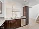 Eat-in kitchen featuring granite countertops, stainless appliances, and dark wood cabinets at 1663 Cloister Ave, Henderson, NV 89014