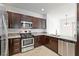 Modern kitchen showcasing stainless steel appliances and dark wood cabinetry at 1663 Cloister Ave, Henderson, NV 89014