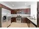 Modern kitchen with stainless steel appliances, granite countertops, and stylish dark wood cabinets at 1663 Cloister Ave, Henderson, NV 89014