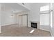 Inviting living room features tile flooring, fireplace, high ceilings, and large windows offering plenty of natural light at 1663 Cloister Ave, Henderson, NV 89014