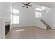 Spacious living room featuring a fireplace, high ceilings, and tiled floors, bathed in natural light from multiple windows at 1663 Cloister Ave, Henderson, NV 89014