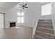 Bright living room adjacent to staircase featuring a fireplace and high ceilings at 1663 Cloister Ave, Henderson, NV 89014