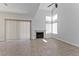 Bright and open living area features a modern fireplace, tile flooring, and large windows for ample natural light at 1663 Cloister Ave, Henderson, NV 89014