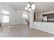 Bright, open-concept space with high ceilings features a fireplace, staircase, and glimpses of the kitchen area at 1663 Cloister Ave, Henderson, NV 89014
