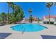 Community pool with bright blue water surrounded by lush landscaping, ideal for relaxation at 1663 Cloister Ave, Henderson, NV 89014