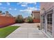 Backyard with manicured lawn, well-placed landscaping, and charming brick-style privacy walls at 1711 Ember Glow Cir, Las Vegas, NV 89119