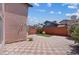 Private backyard with a geometric patterned patio, green lawn, and sturdy privacy walls at 1711 Ember Glow Cir, Las Vegas, NV 89119
