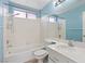 Bright bathroom with a shower, toilet, sink, and light blue walls at 1711 Ember Glow Cir, Las Vegas, NV 89119