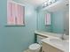 Bathroom features a sink, toilet, mirror, and bright lighting above a window at 1711 Ember Glow Cir, Las Vegas, NV 89119