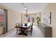 Charming dining room with chandelier, wood table, buffet, and backyard access at 1711 Ember Glow Cir, Las Vegas, NV 89119