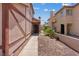 A home with a dark front door, a landscaped yard, and partial views of neighboring homes at 1711 Ember Glow Cir, Las Vegas, NV 89119