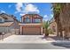 Charming two-story home featuring a two-car garage, well-maintained landscaping, and a welcoming facade at 1711 Ember Glow Cir, Las Vegas, NV 89119