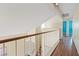Bright upstairs hallway with hardwood floors, natural lighting, and railing at 1711 Ember Glow Cir, Las Vegas, NV 89119