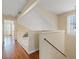 Upstairs hallway with hardwood floors, with railing and natural lighting at 1711 Ember Glow Cir, Las Vegas, NV 89119