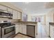 Bright kitchen features granite countertops, stainless steel appliances, and backyard access at 1711 Ember Glow Cir, Las Vegas, NV 89119