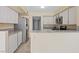 Efficient kitchen features granite countertops, tile flooring, and stainless steel appliances at 1711 Ember Glow Cir, Las Vegas, NV 89119
