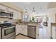 Updated kitchen features granite countertops, stainless steel appliances, and adjacent dining area at 1711 Ember Glow Cir, Las Vegas, NV 89119