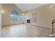 Spacious living room with tile flooring, fireplace, and large windows offering plenty of natural light at 1711 Ember Glow Cir, Las Vegas, NV 89119