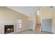 Living room featuring high ceiling, fireplace, tile flooring, and staircase at 1711 Ember Glow Cir, Las Vegas, NV 89119