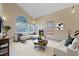 Bright living room boasts fireplace, vaulted ceiling, and ample natural light from large windows at 1711 Ember Glow Cir, Las Vegas, NV 89119