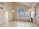 Bright, spacious living area with tile floors, a fireplace, and large windows at 1711 Ember Glow Cir, Las Vegas, NV 89119