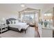 Comfortable main bedroom featuring a seating area, bay windows and a serene color palette at 1711 Ember Glow Cir, Las Vegas, NV 89119
